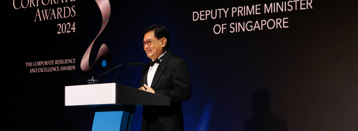 Man in tuxedo at podium, "Corporate Awards 2024", "Deputy Prime Minister of Singapore"
